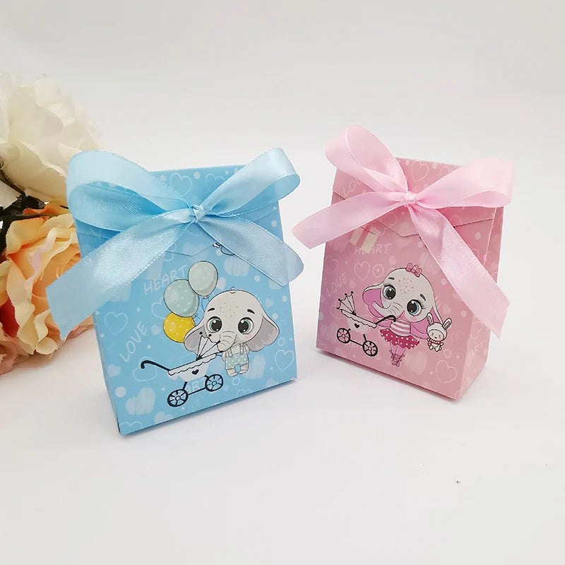 Two decorative boxes with cartoon elephants and ribbons on a white background