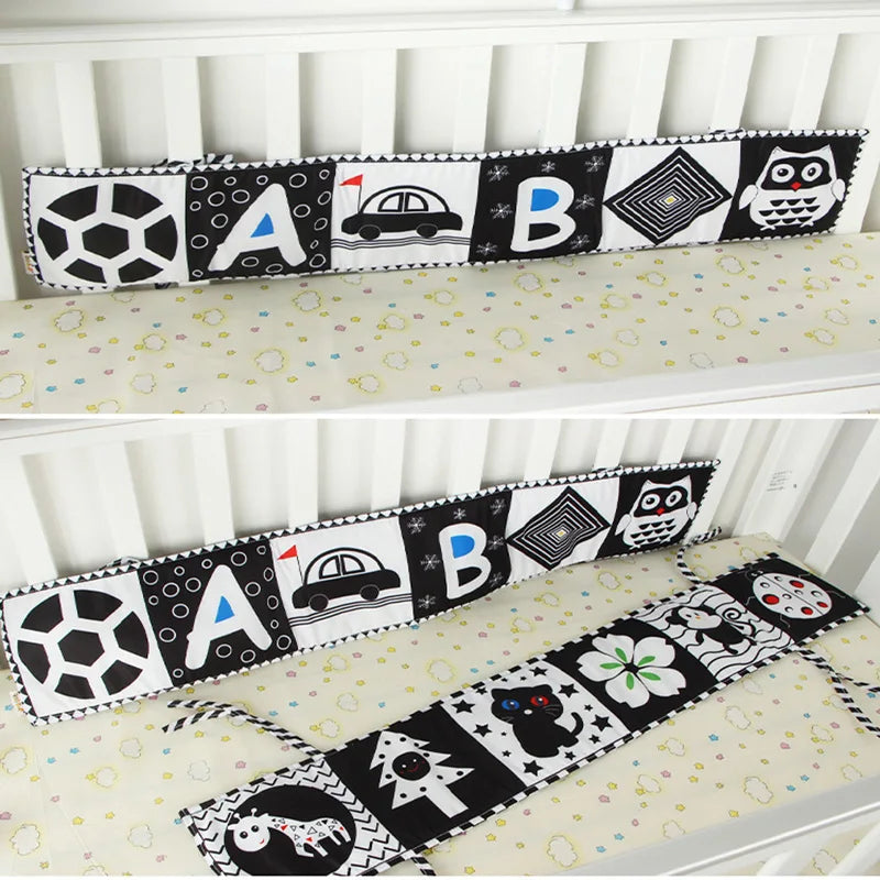 Crib bumper with alphabet and animal patterns on a white crib