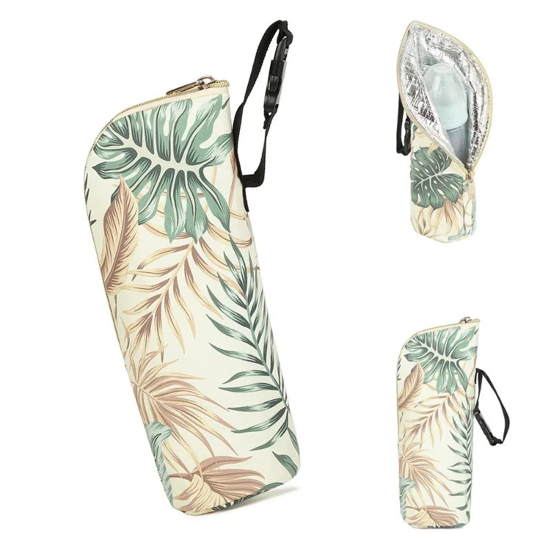 Tropical leaf-patterned umbrella, case, and cover on a white background