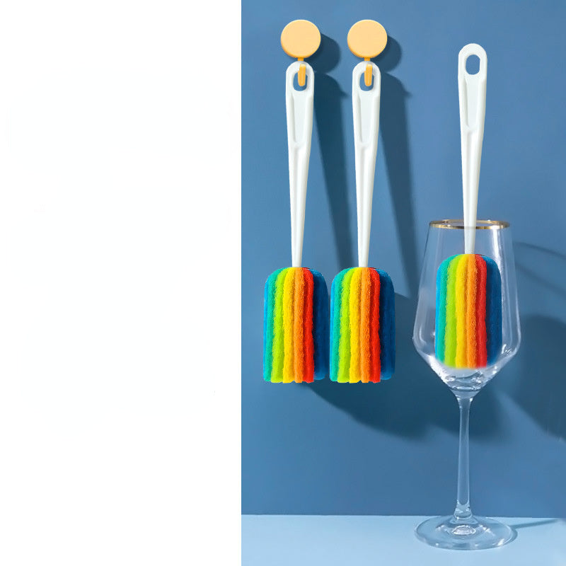Two rainbow-colored brush tools with a clear glass on a blue background