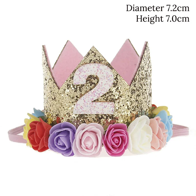 Gold tiara with number '2' and floral decorations on a white background