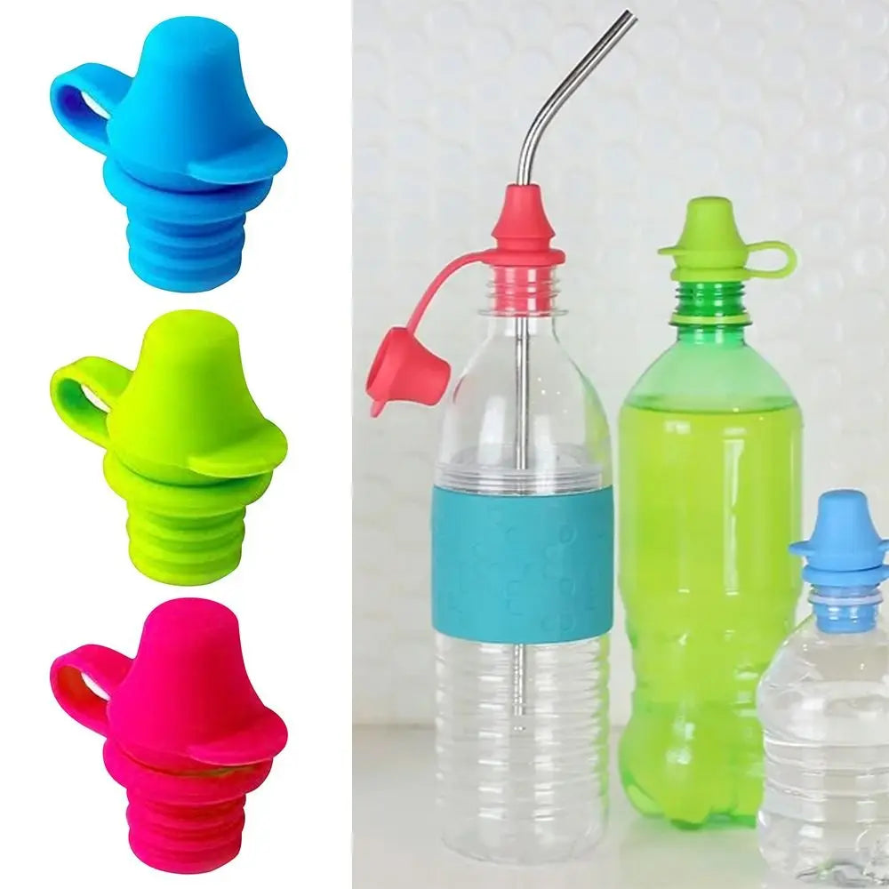Silicone bottle caps in red, blue, and green for anti-spill top spout adapters by Nestacular.