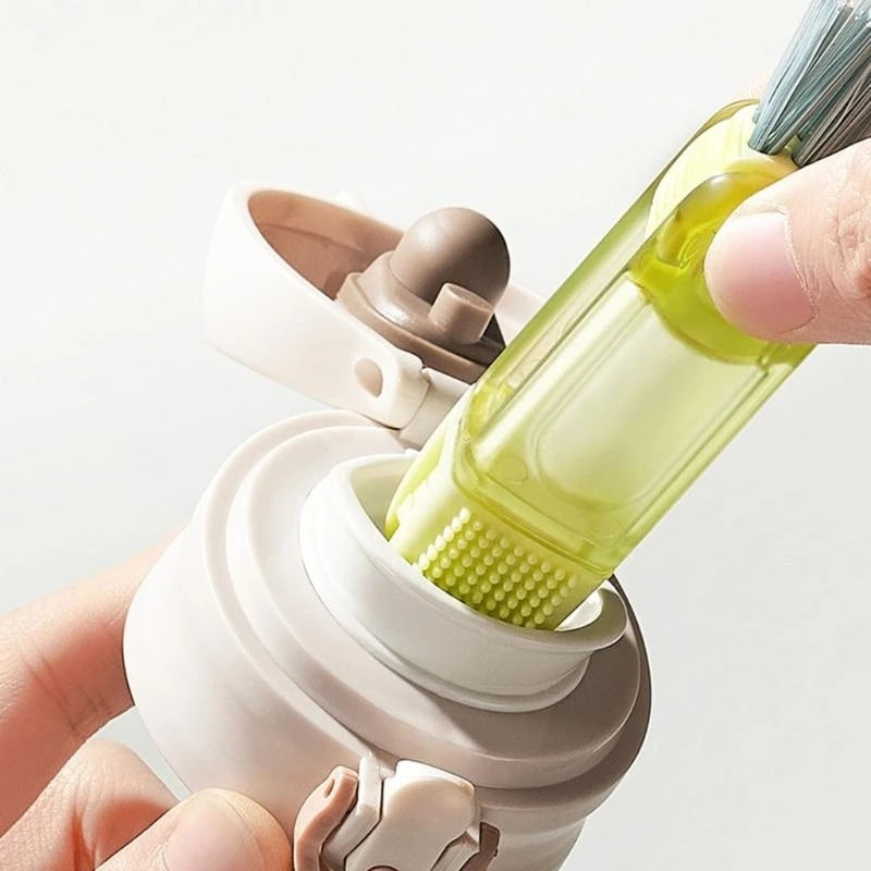 Bottle brush cleaning tool with a green brush head being inserted into a bottle.