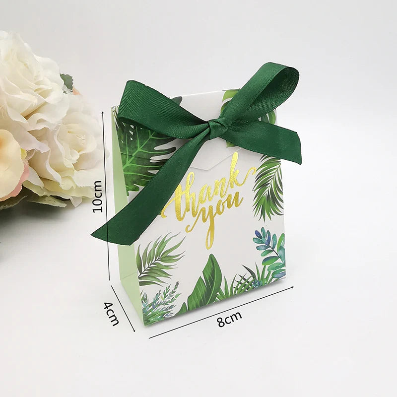 Gift box with green ribbon and tropical leaf design, featuring 'thank you' text.