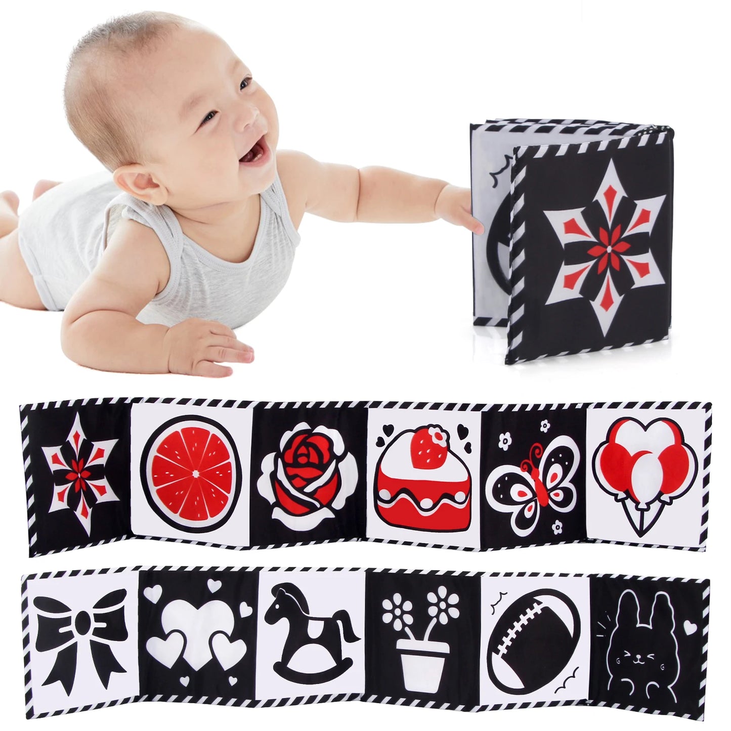 Baby playing with a soft book featuring black, white, and red patterns.