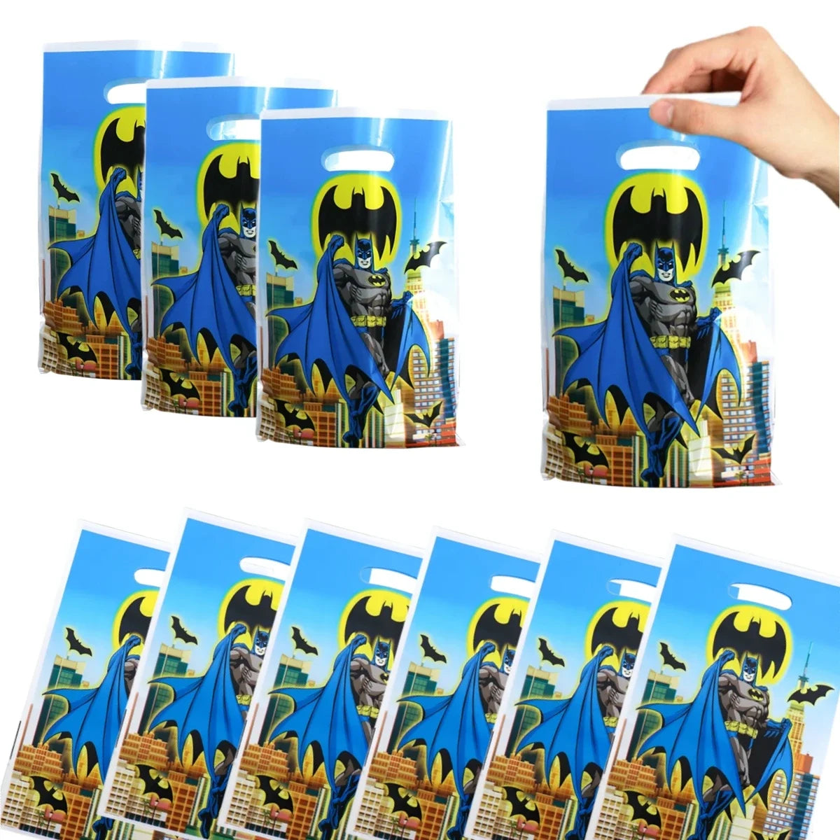 Batman-themed goodie bags with a hand holding one bag.