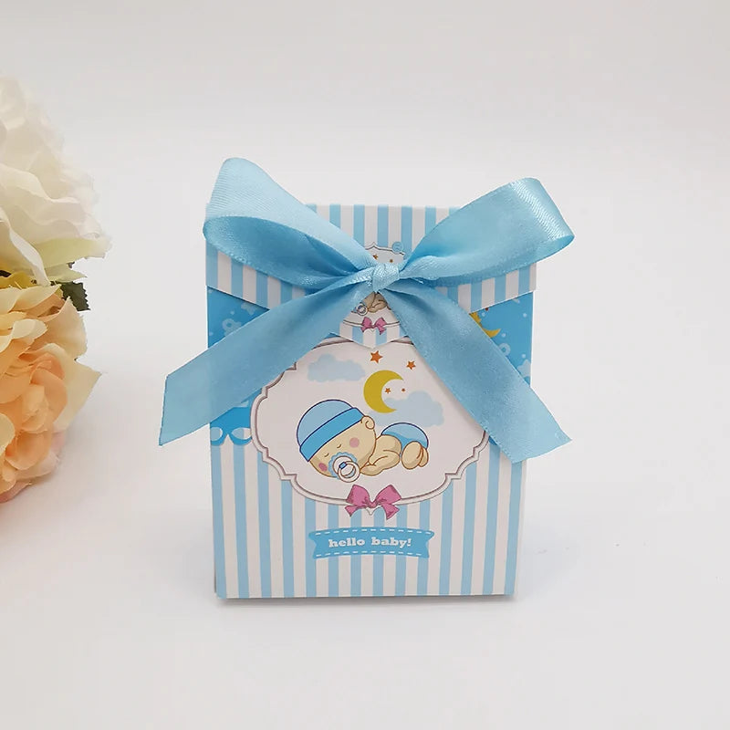 Gift box with blue ribbon and baby-themed design on a white background