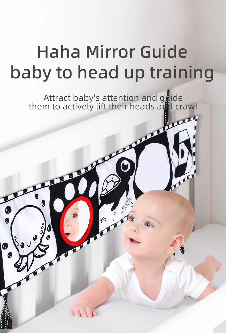 Baby in a crib with a 'Haha Mirror Guide' attached, designed to help with head-up training.