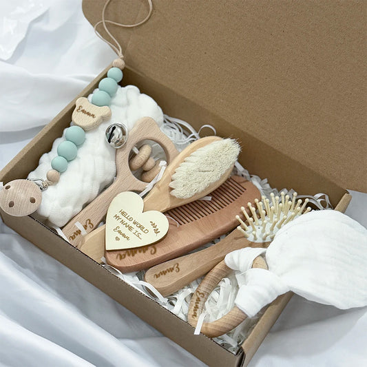Baby care product set with wooden items in a box on a white background