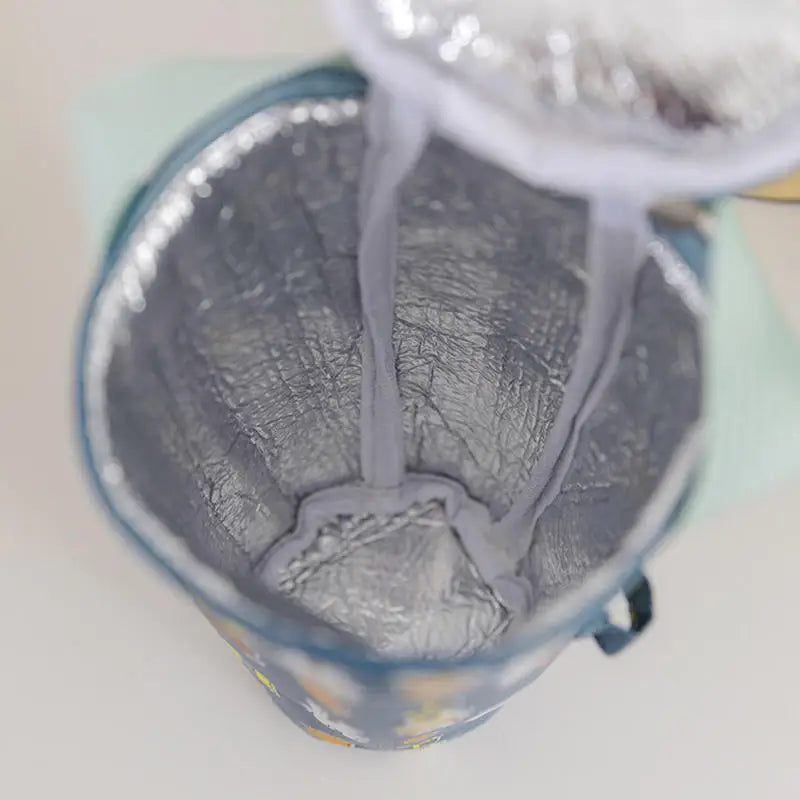Close-up of a metallic cup with a textured interior on a light background