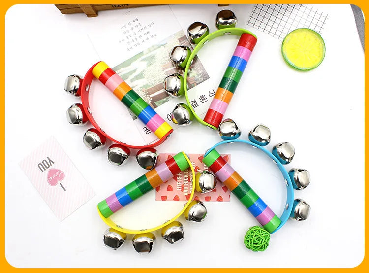 Colorful children's handbell toys on a white surface with a yellow border.