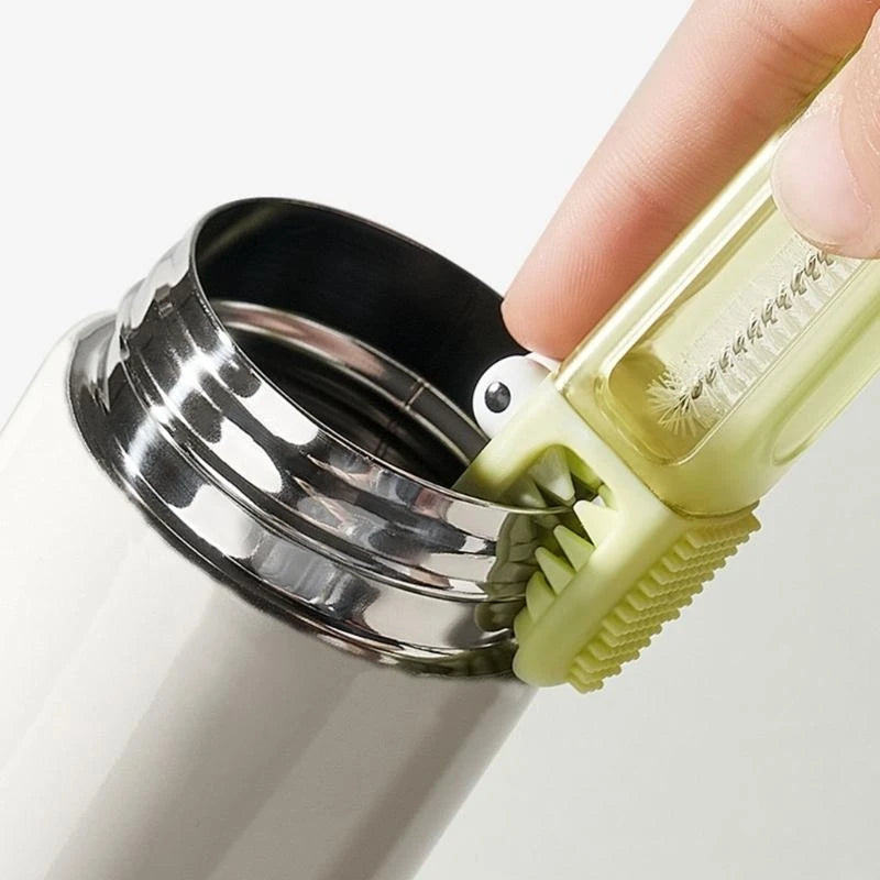 Hand using a green bottle brush to clean the interior of a white water bottle.