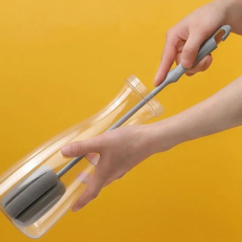 Person using a bottle cleaning brush with a yellow background