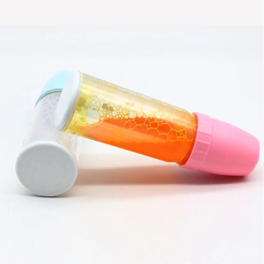 Nestacular baby doll feeding bottle set with colorful magic juice in plastic, featuring pink and blue caps.