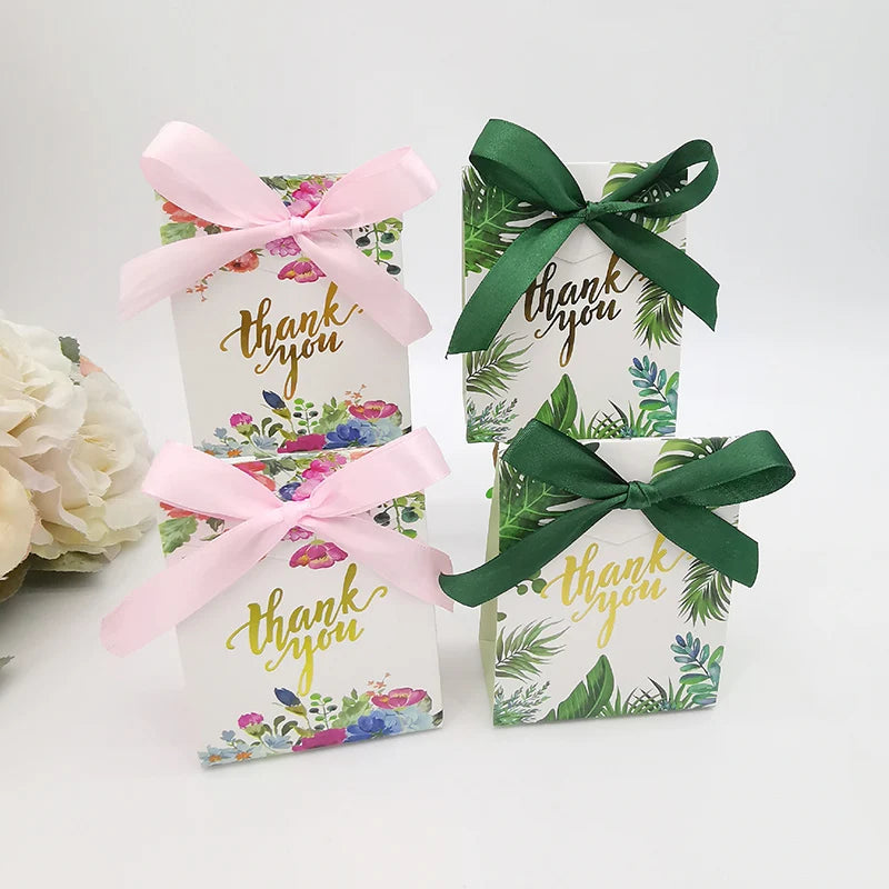 Three gift boxes with floral designs and 'thank you' text, tied with pink and green ribbons.