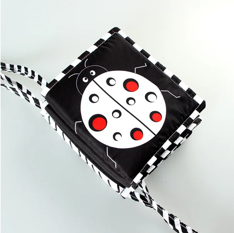 Foldable book with ladybug design on a white background