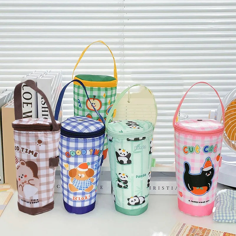 Set of colorful insulated drink containers with cartoon designs on a table.