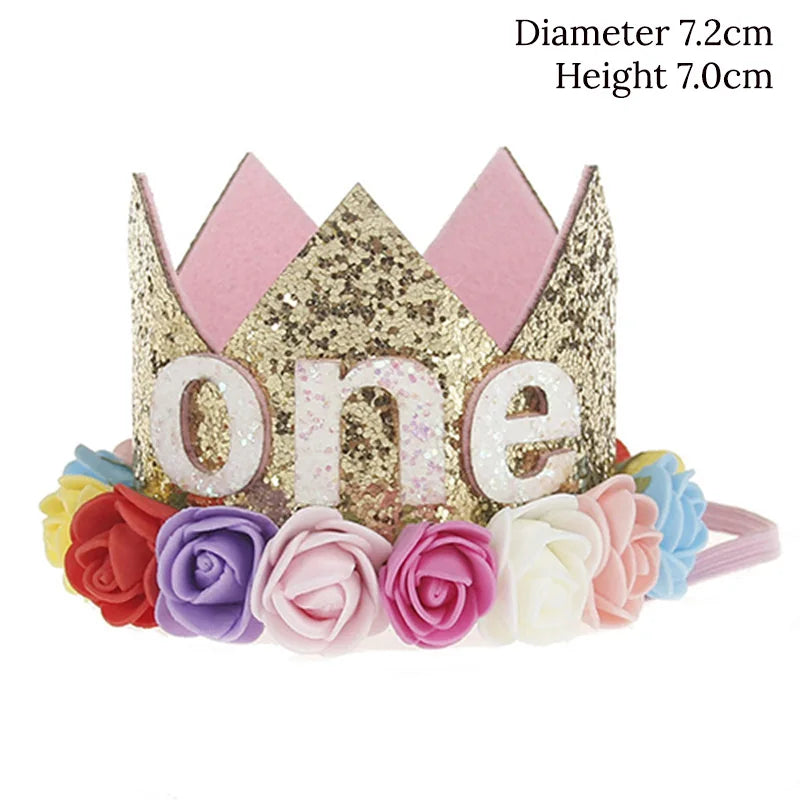 Gold tiara with 'one' letter, pink and purple flowers on a white background