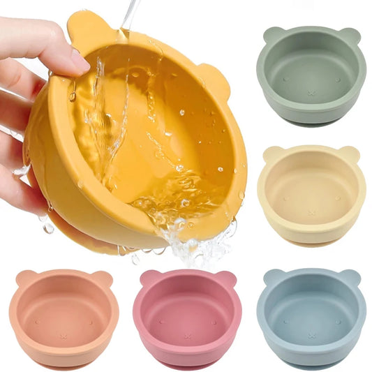Set of colorful silicone pet bowls with a hand pouring water into a yellow bowl.