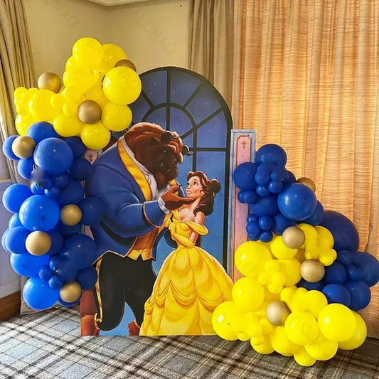 Decorative setup with balloons shaped like Belle and the Beast from Beauty and the Beast, with a checkered floor and curtains in the background.