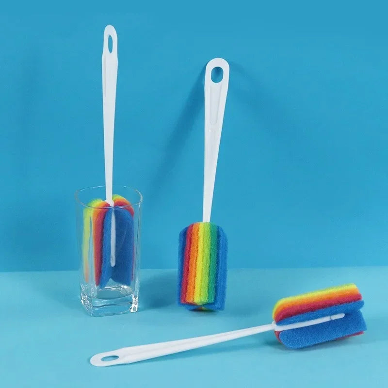 Set of three colorful bottle brushes with rainbow bristle patterns on a blue background.