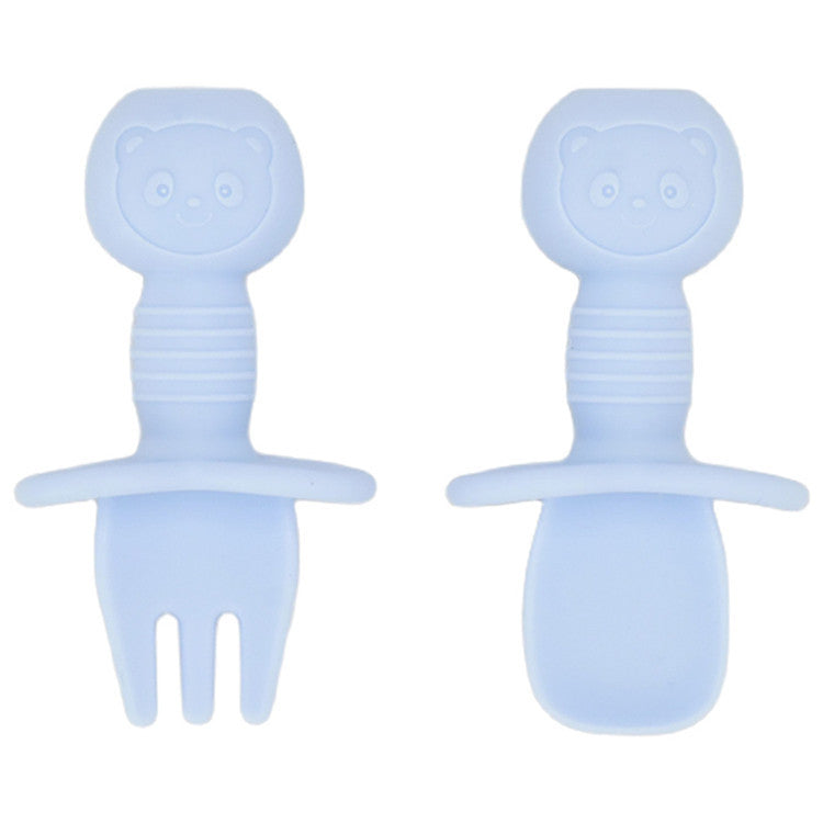 Two blue baby utensils with faces on a white background
