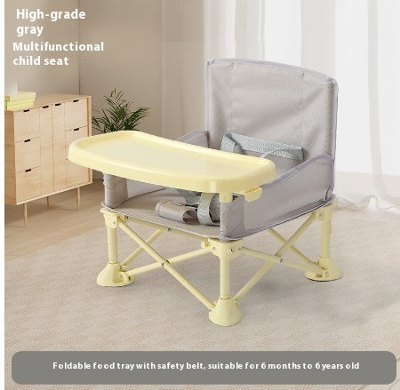 Multifunctional child seat with a foldable food tray in a room setting.
