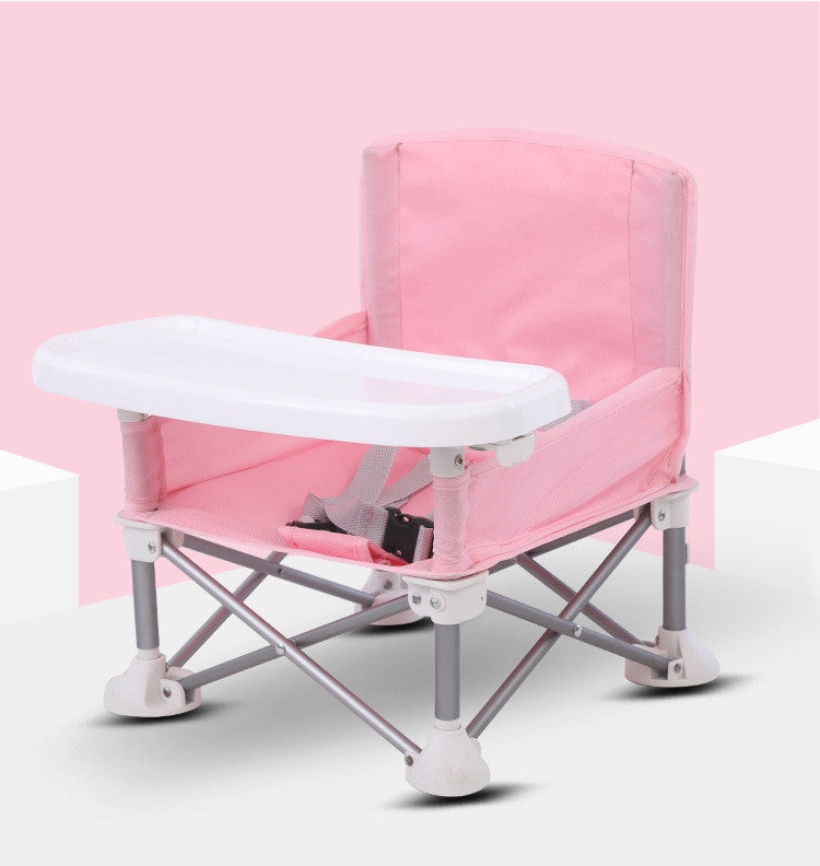 Pink and white folding chair with a tray on a pink background