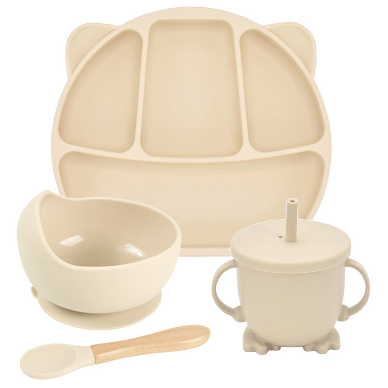 Beige children's dining set with plate, bowl, cup, and spoon on a white background