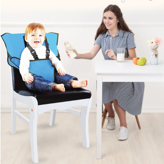 Child in a blue high chair with a woman at a table with food