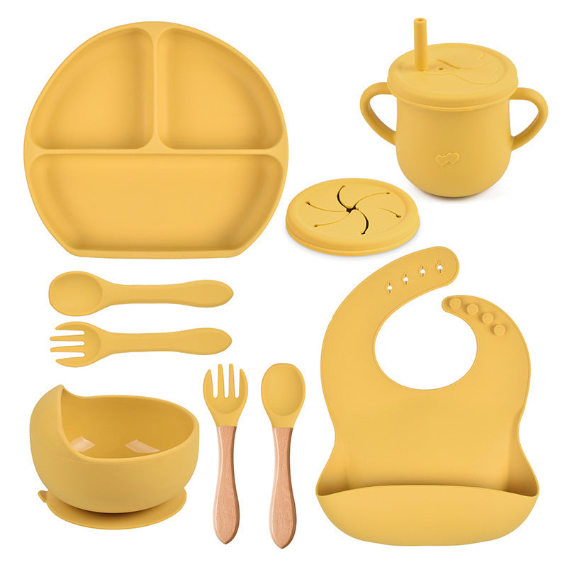Yellow silicone baby吃饭 set including plate, cup, bowl, utensils, and bib on a white background