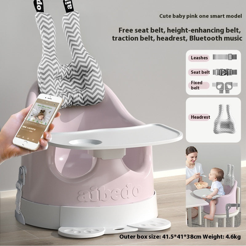Pink baby high chair with smartphone app interface, multiple belts, and a child using the chair.