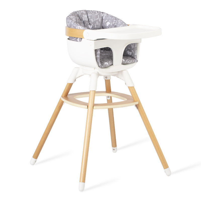White and wooden high chair with gray cushion on a white background