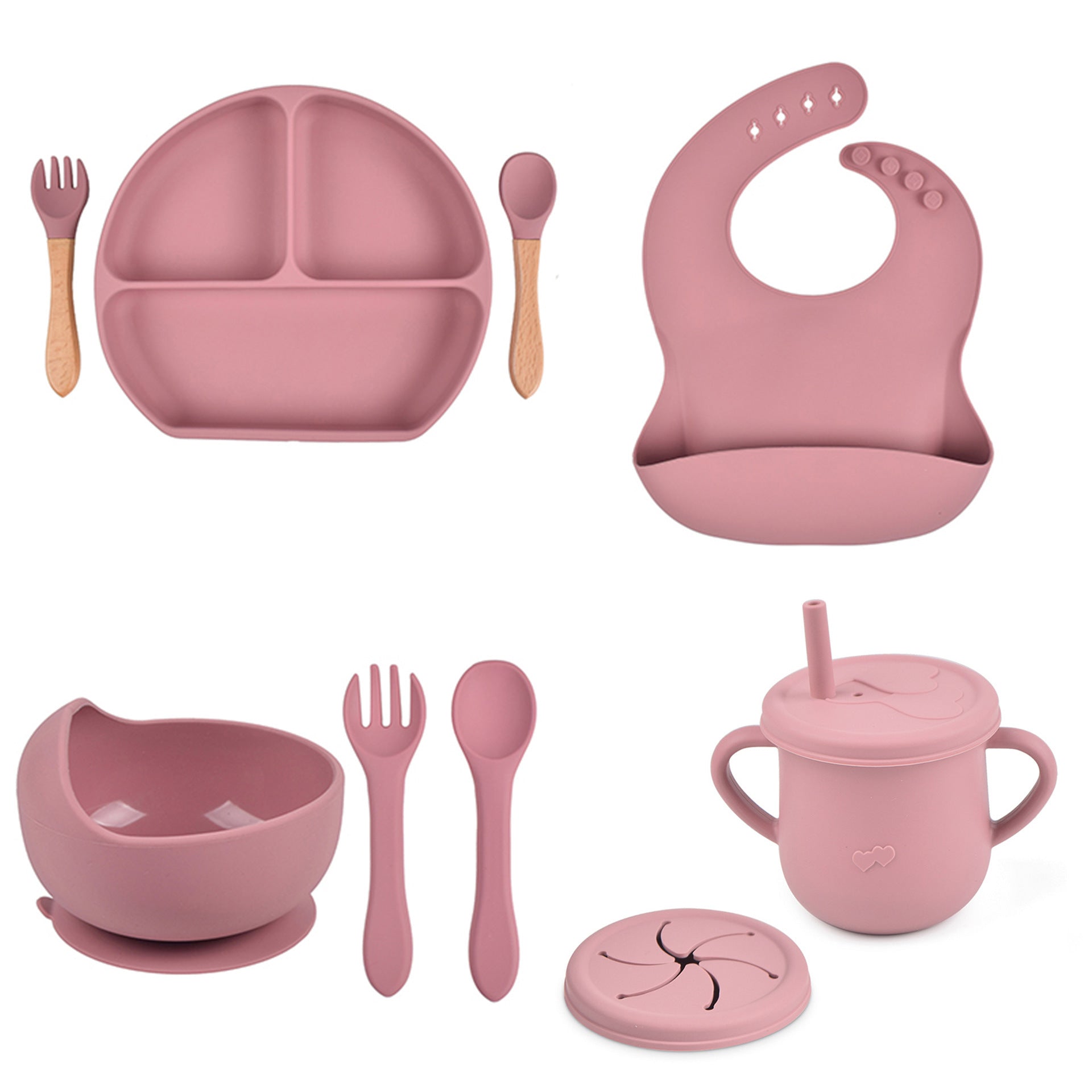Pink children's dining set including plate, bowl, cup, utensils, and bib on a white background