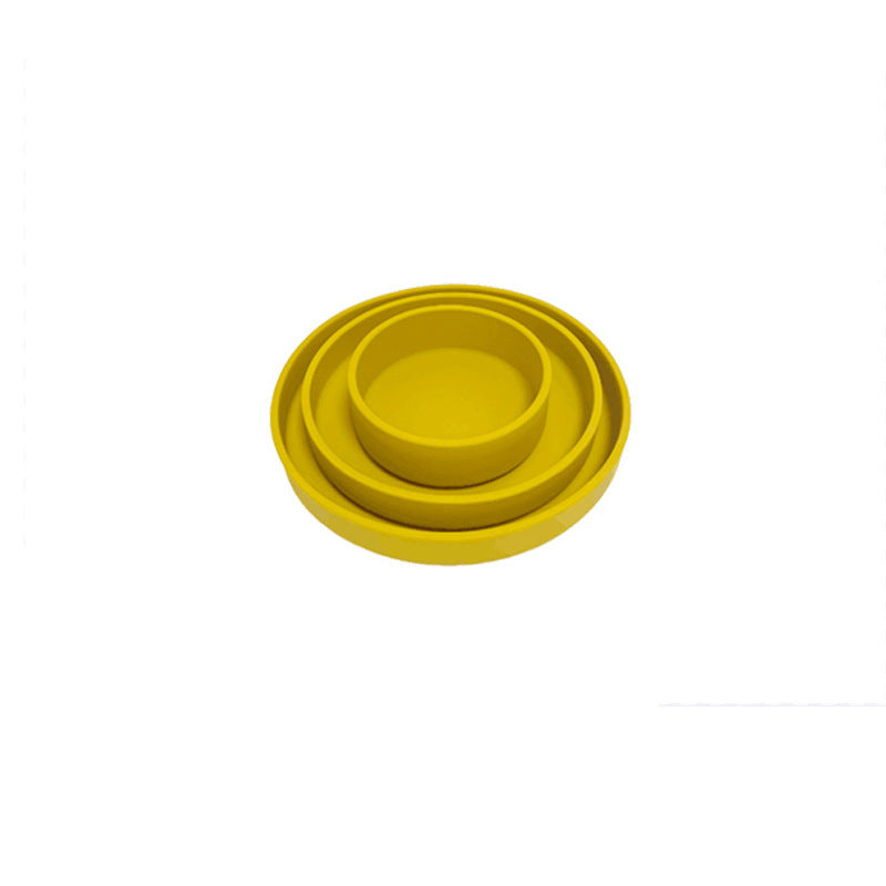 Yellow silicone bowl on a white background