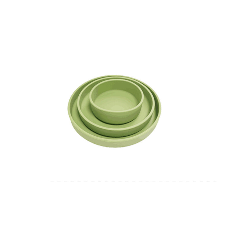 Set of three green silicone bowls on a white background