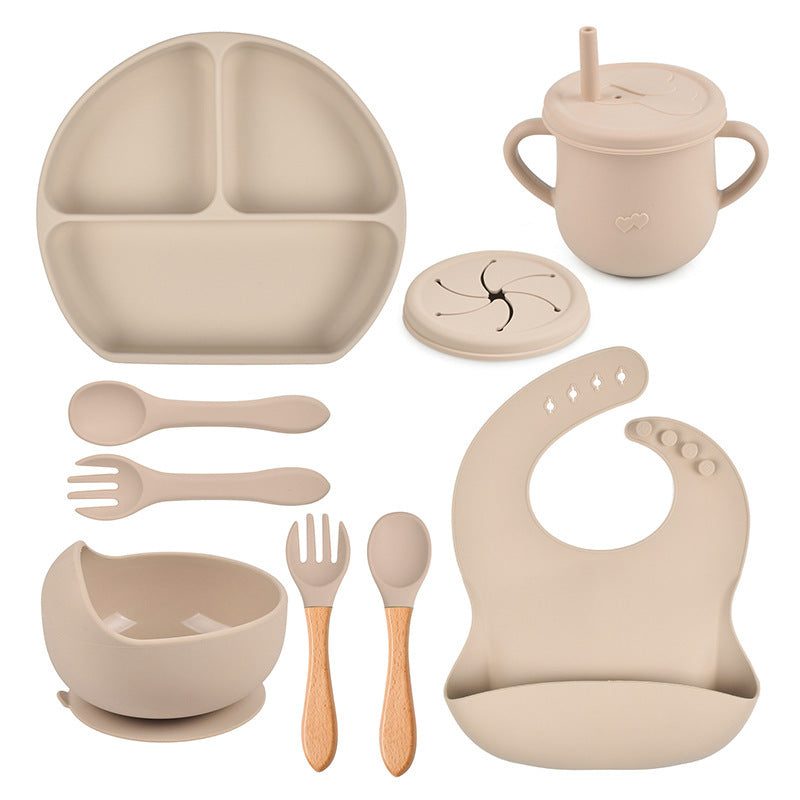 Beige baby吃饭 and utensils set on a white background