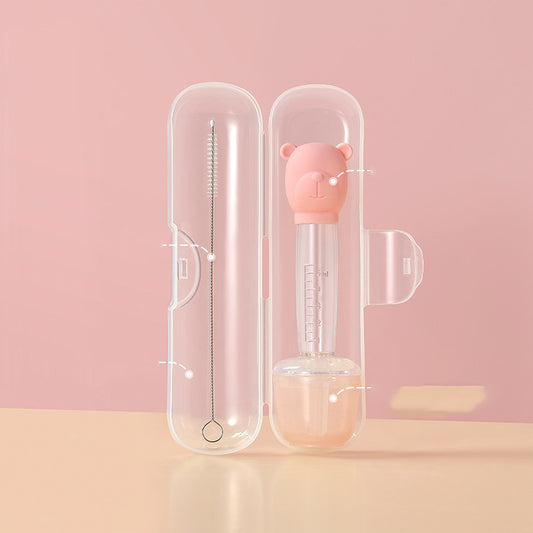 Pink baby bottle with bear design in a clear case on a pink background
