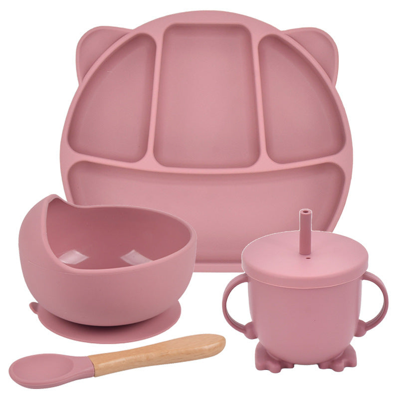 Pink silicone dining set with plate, bowl, cup, and spoon on a white background