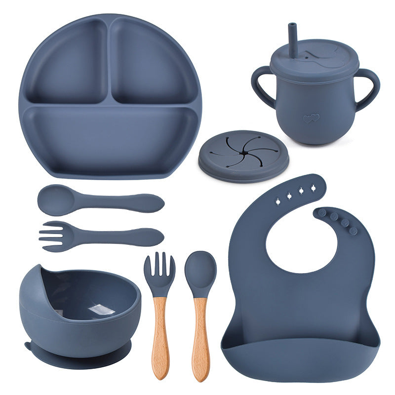 Collection of blue silicone baby feeding utensils and accessories on a white background