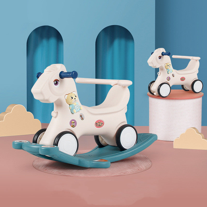 Children's rocking horse toy with a blue base on a pink platform against a blue wall.