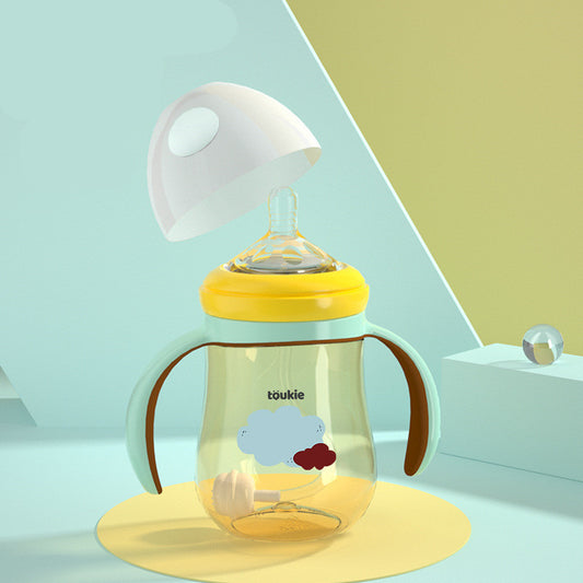 Baby bottle with yellow cap and cloud design on a light blue background