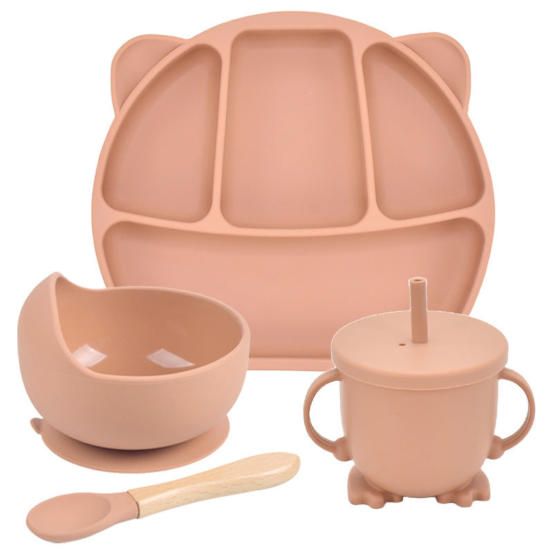 Set of pink silicone dining utensils including a plate, bowl, cup, and spoon on a white background.
