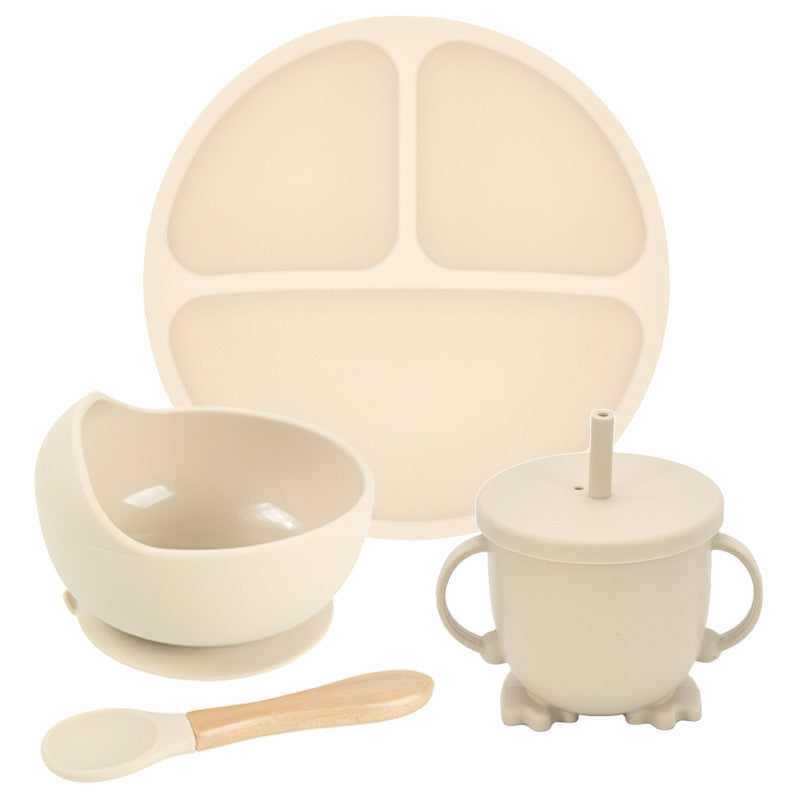 Beige children's dining set with plate, bowl, cup, and spoon on a white background