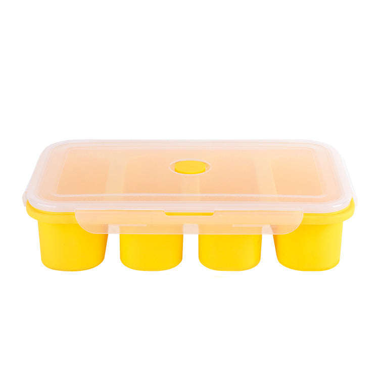 Yellow ice cube tray with a clear lid on a white background