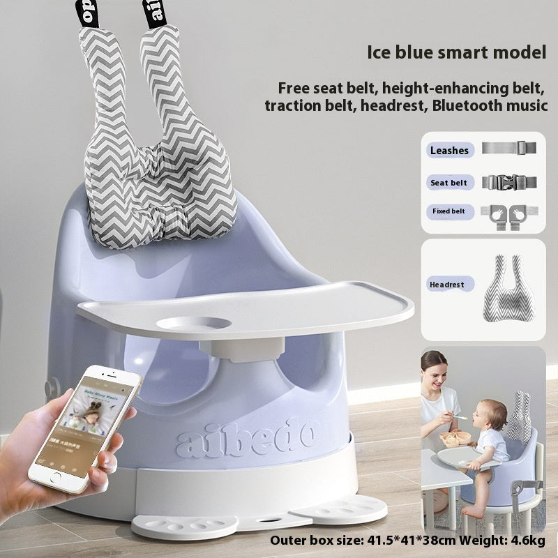 Baby high chair with various accessories and a smartphone app, on a light gray background.