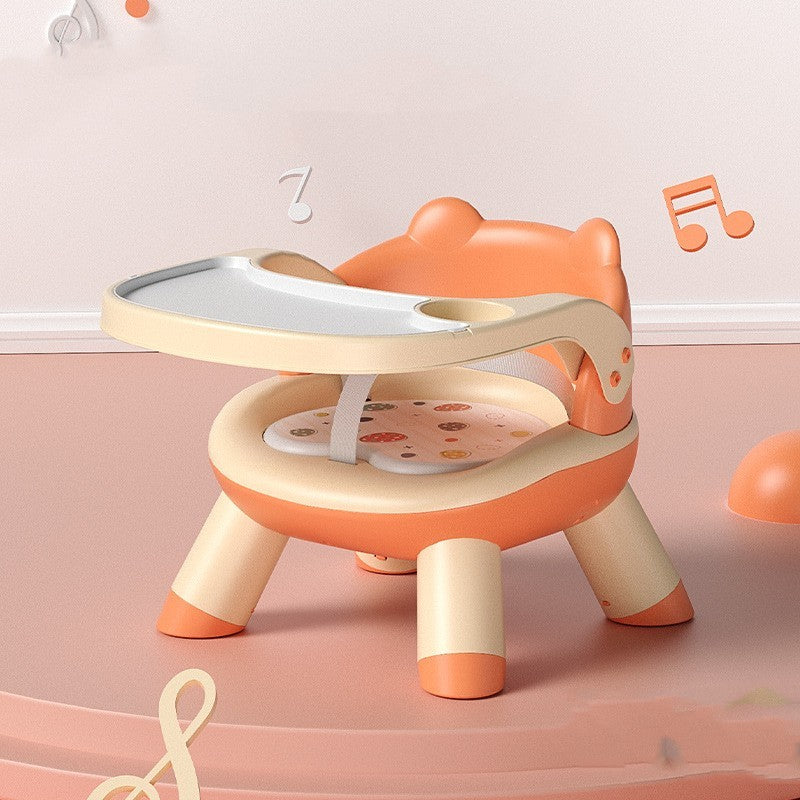 Children's chair with a tray on a pink background