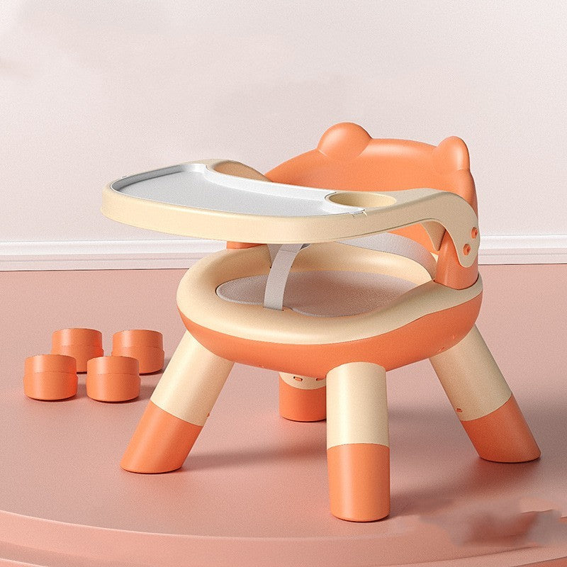 Children's play table with toy cups on a pink floor and light pink wall