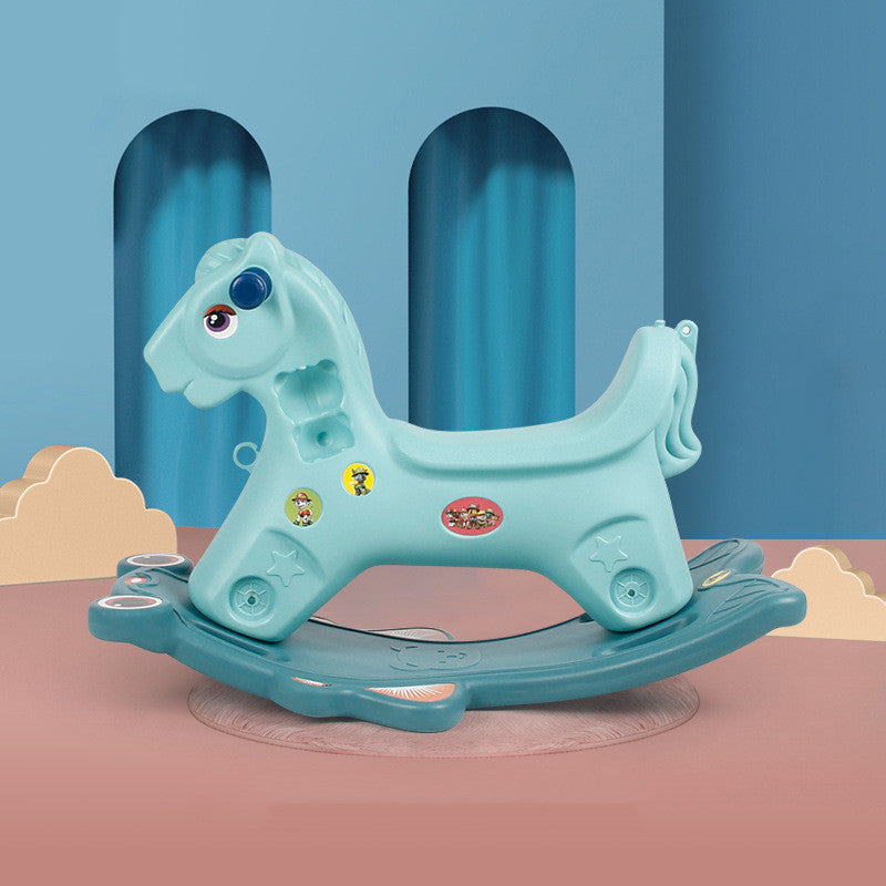Blue rocking horse toy on a pink platform with a blue curtain background