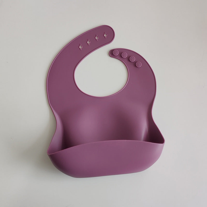 Purple silicone bib on a light gray background